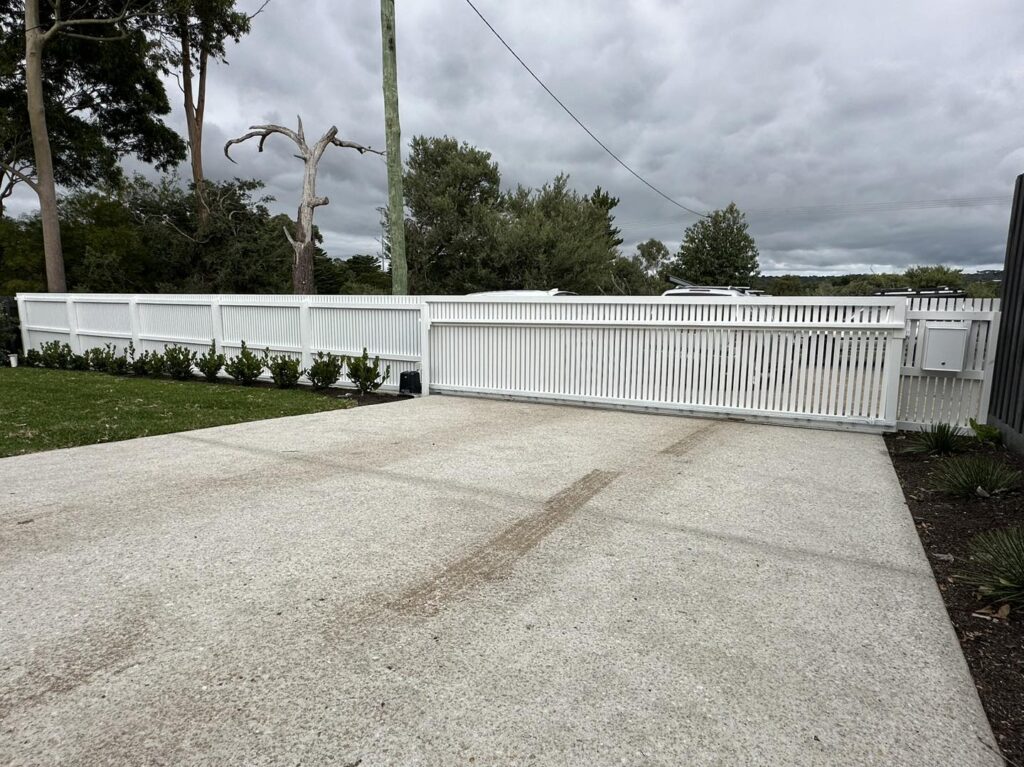White picket fence with automatic gate